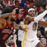 Dec 7, 2025; Chicago, Illinois, USA; Golden State Warriors guard Buddy Hield (7) drives to the basket against Chicago Bulls guard Coby White (0) during the first half at United Center. Mandatory Credit: Kamil Krzaczynski-Imagn Images