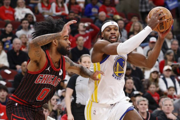 Dec 7, 2025; Chicago, Illinois, USA; Golden State Warriors guard Buddy Hield (7) drives to the basket against Chicago Bulls guard Coby White (0) during the first half at United Center. Mandatory Credit: Kamil Krzaczynski-Imagn Images