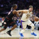Dec 7, 2025; Philadelphia, Pennsylvania, USA; Los Angeles Lakers guard Luka Doncic (77) dribbles past Philadelphia 76ers guard Tyrese Maxey during the second quarter at Xfinity Mobile Arena. Mandatory Credit: Bill Streicher-Imagn Images