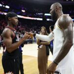 Dec 7, 2025; Philadelphia, Pennsylvania, USA; Los Angeles Lakers forward Lebron James (23) shakes hands with Philadelphia 76ers guard Vj Edgecombe (77) after the game at Xfinity Mobile Arena. Mandatory Credit: Bill Streicher-Imagn Images