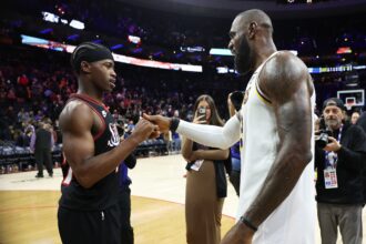 Dec 7, 2025; Philadelphia, Pennsylvania, USA; Los Angeles Lakers forward Lebron James (23) shakes hands with Philadelphia 76ers guard Vj Edgecombe (77) after the game at Xfinity Mobile Arena. Mandatory Credit: Bill Streicher-Imagn Images