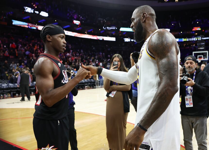 Dec 7, 2025; Philadelphia, Pennsylvania, USA; Los Angeles Lakers forward Lebron James (23) shakes hands with Philadelphia 76ers guard Vj Edgecombe (77) after the game at Xfinity Mobile Arena. Mandatory Credit: Bill Streicher-Imagn Images