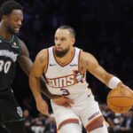 Dec 8, 2025; Minneapolis, Minnesota, USA; Phoenix Suns forward Dillon Brooks (3) works around Minnesota Timberwolves forward Julius Randle (30) in the first quarter at Target Center. Mandatory Credit: Bruce Kluckhohn-Imagn Images