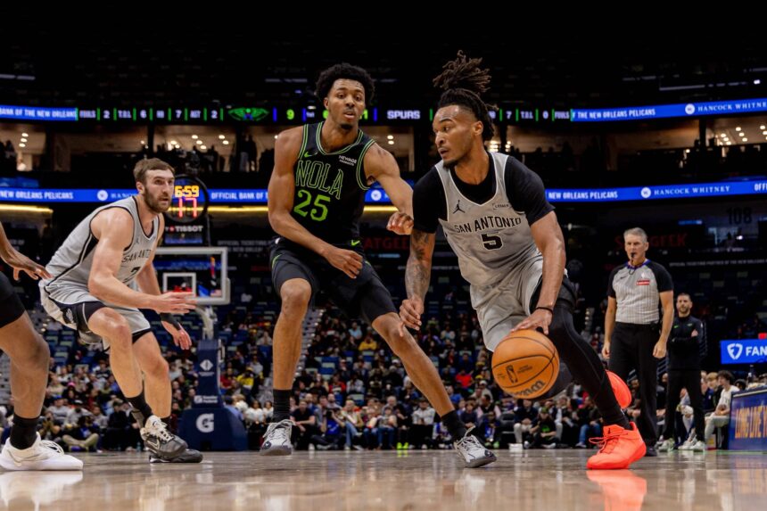 Dec 8, 2025; New Orleans, Louisiana, USA; San Antonio Spurs guard Stephon Castle (5) dribbles against New Orleans Pelicans forward Trey Murphy III (25) during the first half at Smoothie King Center. Mandatory Credit: Stephen Lew-Imagn Images