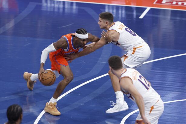 Dec 10, 2025; Oklahoma City, Oklahoma, USA; Oklahoma City Thunder guard Shai Gilgeous-Alexander (2) moves the ball past Phoenix Suns guard Grayson Allen (8) during the first quarter at Paycom Center. Mandatory Credit: Alonzo Adams-Imagn Images