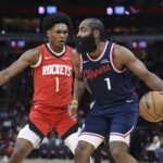 Dec 11, 2025; Houston, Texas, USA; Los Angeles Clippers guard James Harden (1) controls the ball as Houston Rockets guard Amen Thompson (1) defends during the first quarter at Toyota Center. Mandatory Credit: Troy Taormina-Imagn Images