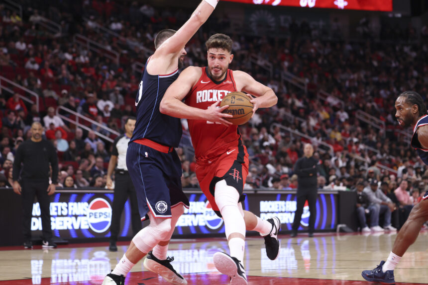 Dec 11, 2025; Houston, Texas, USA; Houston Rockets center Alperen Sengun (28) drives with the ball as Los Angeles Clippers center Ivica Zubac (40) defends during the fourth quarter at Toyota Center. Mandatory Credit: Troy Taormina-Imagn Images