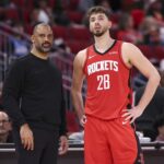 Dec 11, 2025; Houston, Texas, USA; Houston Rockets head coach Ime Udoka and center Alperen Sengun (28) look to the court during the third quarter against the Los Angeles Clippers at Toyota Center. Mandatory Credit: Troy Taormina-Imagn Images