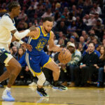 Dec 12, 2025; San Francisco, California, USA; Golden State Warriors guard Stephen Curry (30) drives to the basket against Minnesota Timberwolves forward Jaden McDaniels (3) as head coach Chris Finch looks on during the second quarter at Chase Center. Mandatory Credit: Robert Edwards-Imagn Images