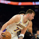 Dec 14, 2025; Phoenix, Arizona, USA; Los Angeles Lakers guard Luka Doncic (77) dribbles the ball during the first half of a game against the Phoenix Suns at Mortgage Matchup Center. Mandatory Credit: Allan Henry-Imagn Images