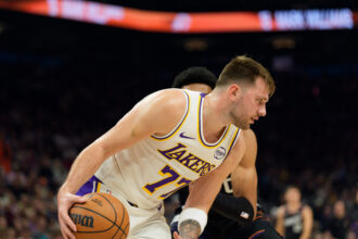 Dec 14, 2025; Phoenix, Arizona, USA; Los Angeles Lakers guard Luka Doncic (77) dribbles the ball during the first half of a game against the Phoenix Suns at Mortgage Matchup Center. Mandatory Credit: Allan Henry-Imagn Images