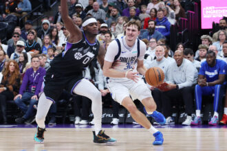 Dec 15, 2025; Salt Lake City, Utah, USA; Dallas Mavericks forward Cooper Flagg (32) moves the ball against Utah Jazz forward Taylor Hendricks (0) during the first quarter at Delta Center. Mandatory Credit: Rob Gray-Imagn Images