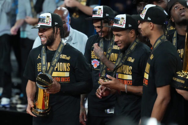 Dec 16, 2025; Las Vegas, Nevada, USA; New York Knicks guard Jalen Brunson (11) holds the MVP trophy after winning the Emirates NBA Cup Final at T-Mobile Arena. Mandatory Credit: Kirby Lee-Imagn Images