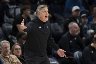 Dec 17, 2025; Minneapolis, Minnesota, USA; Minnesota Timberwolves head coach Chris Finch reacts towards an official after a call against the Memphis Grizzlies in the second half at Target Center. Mandatory Credit: Jesse Johnson-Imagn Images