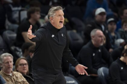 Dec 17, 2025; Minneapolis, Minnesota, USA; Minnesota Timberwolves head coach Chris Finch reacts towards an official after a call against the Memphis Grizzlies in the second half at Target Center. Mandatory Credit: Jesse Johnson-Imagn Images