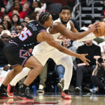 Dec 17, 2025; Chicago, Illinois, USA; Cleveland Cavaliers guard Donovan Mitchell (45) passes the ball away from Chicago Bulls forward Isaac Okoro (35) during the second half at United Center. Mandatory Credit: Matt Marton-Imagn Images
