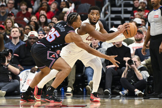 Dec 17, 2025; Chicago, Illinois, USA; Cleveland Cavaliers guard Donovan Mitchell (45) passes the ball away from Chicago Bulls forward Isaac Okoro (35) during the second half at United Center. Mandatory Credit: Matt Marton-Imagn Images
