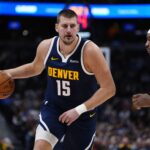 Dec 18, 2025; Denver, Colorado, USA; Orlando Magic center Wendell Carter Jr. (34) defends on Denver Nuggets center Nikola Jokic (15) in the first quarter at Ball Arena. Mandatory Credit: Ron Chenoy-Imagn Images