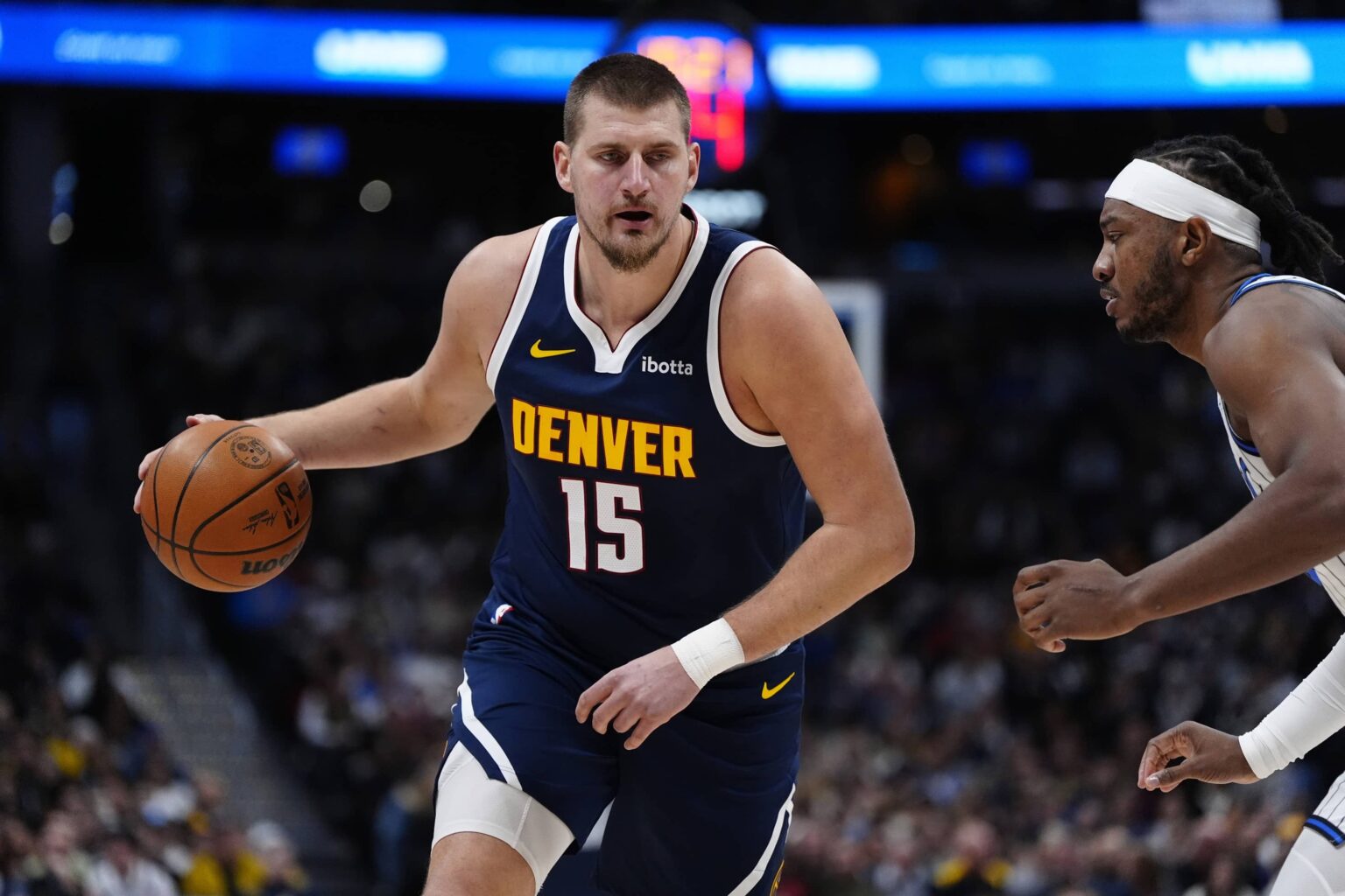 Dec 18, 2025; Denver, Colorado, USA; Orlando Magic center Wendell Carter Jr. (34) defends on Denver Nuggets center Nikola Jokic (15) in the first quarter at Ball Arena. Mandatory Credit: Ron Chenoy-Imagn Images