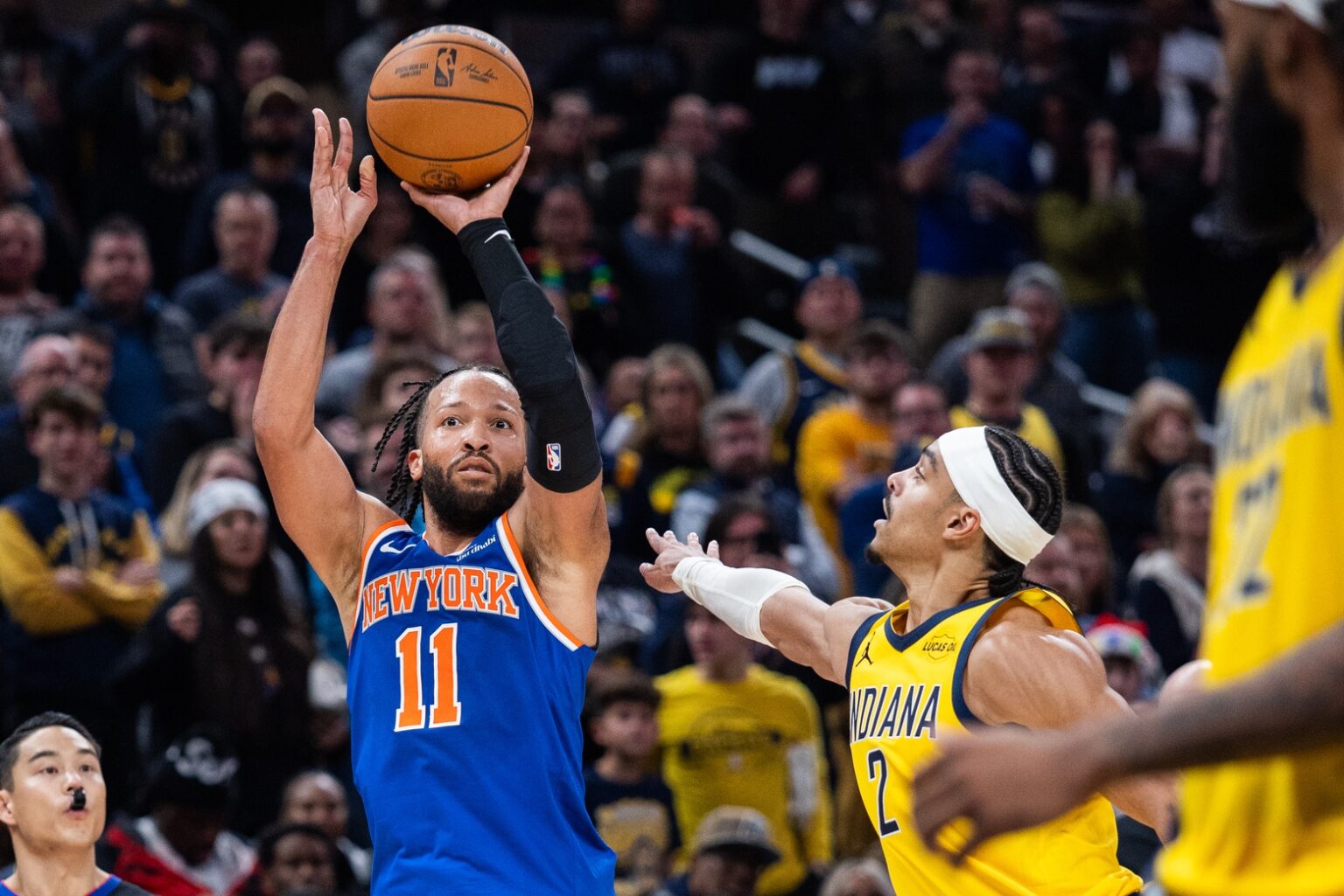 Dec 18, 2025; Indianapolis, Indiana, USA; New York Knicks guard Jalen Brunson (11) shoots the winning shot while Indiana Pacers guard/forward Andrew Nembhard (2) defends in the second half at Gainbridge Fieldhouse. Mandatory Credit: Trevor Ruszkowski-Imagn Images