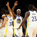 Dec 18, 2025; Phoenix, Arizona, USA; Golden State Warriors forward Jimmy Butler III (10) celebrates with guard Stephen Curry (30) and forward Draymond Green (23) against the Phoenix Suns in the second half at Mortgage Matchup Center. Mandatory Credit: Mark J. Rebilas-Imagn Images
