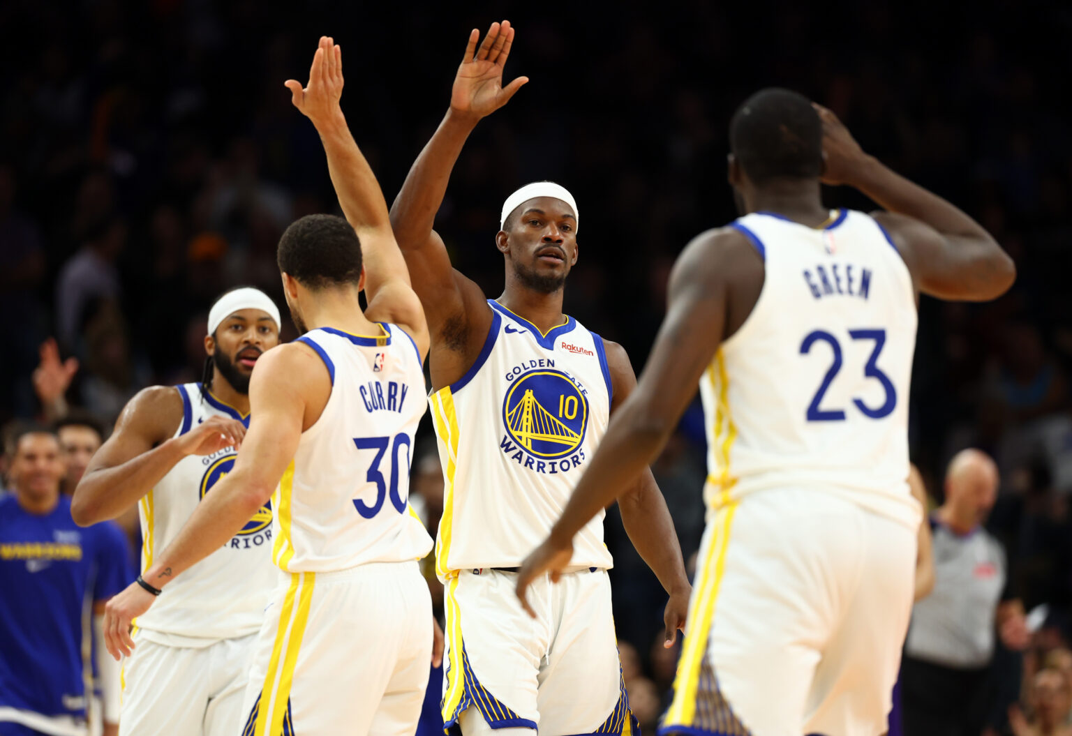 Dec 18, 2025; Phoenix, Arizona, USA; Golden State Warriors forward Jimmy Butler III (10) celebrates with guard Stephen Curry (30) and forward Draymond Green (23) against the Phoenix Suns in the second half at Mortgage Matchup Center. Mandatory Credit: Mark J. Rebilas-Imagn Images