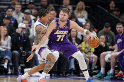 Dec 18, 2025; Salt Lake City, Utah, USA; Los Angeles Lakers forward/guard Luka Doncic (77) tries to keep Utah Jazz guard Keyonte George (3) away from the ball during the second half at Delta Center. Mandatory Credit: Chris Nicoll-Imagn Images