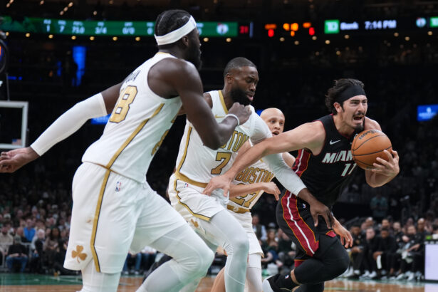 Dec 19, 2025; Boston, Massachusetts, USA; Miami Heat forward Jaime Jaquez Jr. (11) drives the ball against Boston Celtics guard Jaylen Brown (7) in the first quarter at TD Garden. Mandatory Credit: David Butler II-Imagn Images