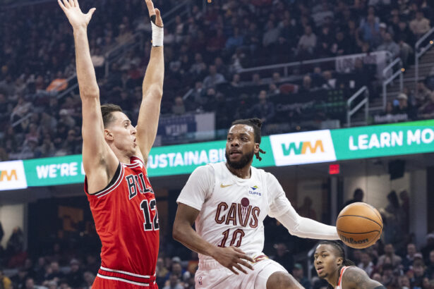 Dec 19, 2025; Cleveland, Ohio, USA; Cleveland Cavaliers guard Darius Garland (10) passes the ball past Chicago Bulls forward-center Zach Collins (12) during the first quarter at Rocket Arena. Mandatory Credit: Scott Galvin-Imagn Images