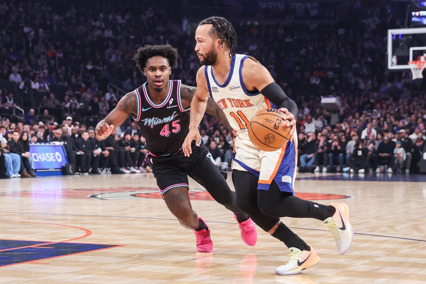 Dec 21, 2025; New York, New York, USA; New York Knicks guard Jalen Brunson (11) drives past Miami Heat guard Davion Mitchell (45) in the first quarter at Madison Square Garden. Mandatory Credit: Wendell Cruz-Imagn Images