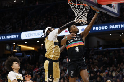 Dec 21, 2025; Washington, District of Columbia, USA; San Antonio Spurs guard De'Aaron Fox (4) shoots the ball as Washington Wizards guard Tre Johnson (12) defends in the first quarter at Capital One Arena. Mandatory Credit: Geoff Burke-Imagn Images