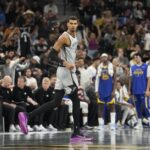 Nov 14, 2025; San Antonio, Texas, USA; San Antonio Spurs forward Victor Wembanyama (1) gets back on defense after scoring a three-point basket during the second half against the Golden State Warriors at Frost Bank Center. Mandatory Credit: Scott Wachter-Imagn Images