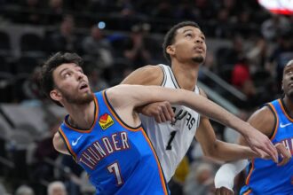 Oklahoma City Thunder forward Chet Holmgren (7) and San Antonio Spurs center Victor Wembanyama (1) battle for position in the first half at Frost Bank Center.