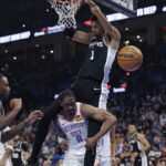 Dec 25, 2025; Oklahoma City, Oklahoma, USA; San Antonio Spurs forward Victor Wembanyama (1) dunks over Oklahoma City Thunder guard Jalen Williams (8) during the second quarter at Paycom Center. Mandatory Credit: Alonzo Adams-Imagn Images