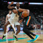 Dec 29, 2025; San Antonio, Texas, USA; San Antonio Spurs forward Victor Wembanyama (1) drives in against Cleveland Cavaliers center Evan Mobley (4) in the second half at Frost Bank Center. Mandatory Credit: Daniel Dunn-Imagn Images