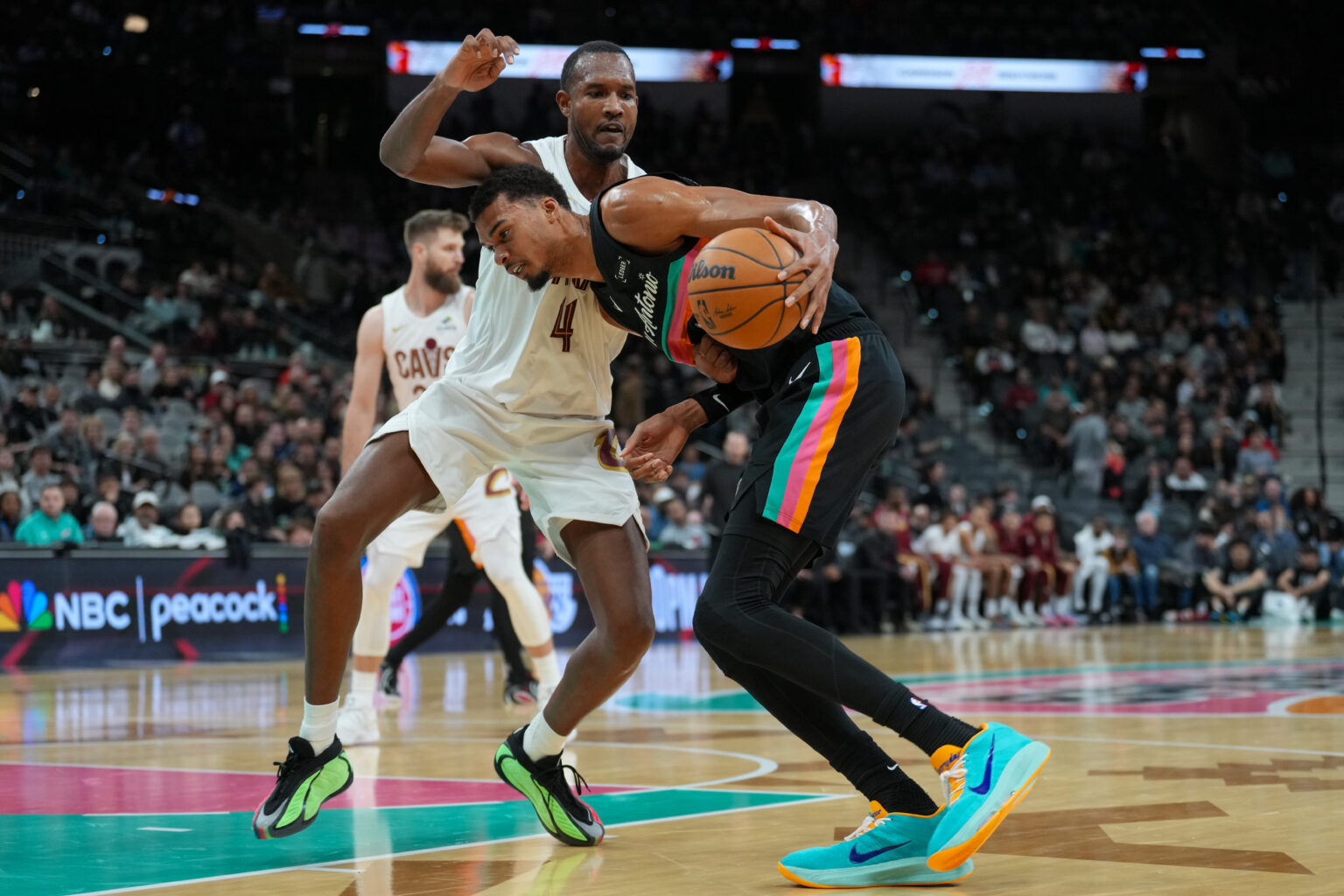 Dec 29, 2025; San Antonio, Texas, USA; San Antonio Spurs forward Victor Wembanyama (1) drives in against Cleveland Cavaliers center Evan Mobley (4) in the second half at Frost Bank Center. Mandatory Credit: Daniel Dunn-Imagn Images