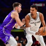 Nov 5, 2025; Los Angeles, California, USA; San Antonio Spurs forward Victor Wembanyama (1) controls the ball against Los Angeles Lakers guard Luka Doncic (77) during the second half at Crypto.com Arena. Mandatory Credit: Gary A. Vasquez-Imagn Images