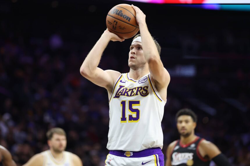 Philadelphia, Pennsylvania, USA; Los Angeles Lakers guard Austin Reaves (15) shoots a foul shot against the Philadelphia 76ers during the fourth quarter at Xfinity Mobile Arena. Mandatory Credit: Bill Streicher-Imagn Images