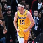 Toronto, Ontario, CAN; Los Angeles Lakers guard Austin Reaves (15) reacts after scoring a basket against the Toronto Raptors in the second half at Scotiabank Arena. Mandatory Credit: Dan Hamilton-Imagn Images