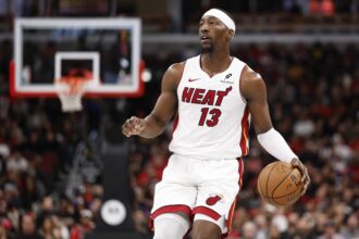Chicago, Illinois, USA; Miami Heat center Bam Adebayo (13) brings the ball up court against the Chicago Bulls during the second half at United Center. Mandatory Credit: Kamil Krzaczynski-Imagn Images
