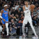 Feb 29, 2024; San Antonio, Texas, USA; San Antonio Spurs center Victor Wembanyama (1) looks down the court beside Oklahoma City Thunder guard Shai Gilgeous-Alexander (2) in the first half at Frost Bank Center. Mandatory Credit: Daniel Dunn-Imagn Images