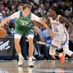 Dallas, Texas, USA; Dallas Mavericks forward Cooper Flagg (32) looks to move the ball past Oklahoma City Thunder guard Cason Wallace (22) during the game between the Mavericks and the Thunder at the American Airlines Center. Mandatory Credit: Jerome Miron-Imagn Images