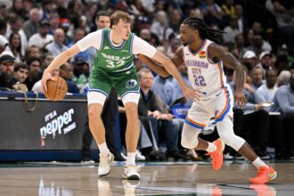 Dallas, Texas, USA; Dallas Mavericks forward Cooper Flagg (32) looks to move the ball past Oklahoma City Thunder guard Cason Wallace (22) during the game between the Mavericks and the Thunder at the American Airlines Center. Mandatory Credit: Jerome Miron-Imagn Images