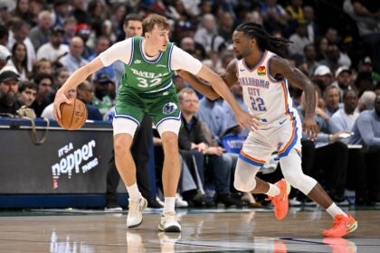 Dallas, Texas, USA; Dallas Mavericks forward Cooper Flagg (32) looks to move the ball past Oklahoma City Thunder guard Cason Wallace (22) during the game between the Mavericks and the Thunder at the American Airlines Center. Mandatory Credit: Jerome Miron-Imagn Images