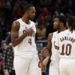 Washington, District of Columbia, USA; Cleveland Cavaliers guard Donovan Mitchell (45) talks with Cavaliers center Evan Mobley (4) and Cavaliers guard Darius Garland (10) during a stoppage in play against the Washington Wizards in the second half at Capital One Arena. Mandatory Credit: Geoff Burke-Imagn Images