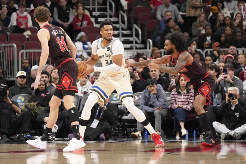 Chicago, Illinois, USA; Chicago Bulls guard Coby White (0) defends Milwaukee Bucks forward Giannis Antetokounmpo (34)during the first half at United Center. Mandatory Credit: David Banks-Imagn Images