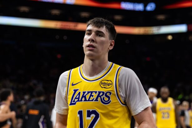 Phoenix, Arizona, USA; Los Angeles Lakers forward Jake LaRavia (12) against the Phoenix Suns at Mortgage Matchup Center. Mandatory Credit: Mark J. Rebilas-Imagn Images