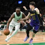 Boston, Massachusetts, USA; Boston Celtics guard Jaylen Brown (7) drives to the basket against Los Angeles Lakers guard Austin Reaves (15) during the fourth quarter at the TD Garden. Mandatory Credit: Brian Fluharty-Imagn Images