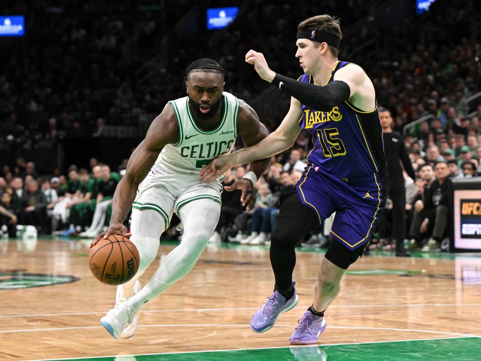 Boston, Massachusetts, USA; Boston Celtics guard Jaylen Brown (7) drives to the basket against Los Angeles Lakers guard Austin Reaves (15) during the fourth quarter at the TD Garden. Mandatory Credit: Brian Fluharty-Imagn Images