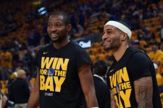 San Francisco, California, USA; Golden State Warriors forward Jonathan Kuminga (00) and guard Gary Payton II (0) warm up before Game 3 of the second round of the 2025 NBA Playoffs against the Minnesota Timberwolves at Chase Center. Mandatory Credit: David Gonzales-Imagn Images